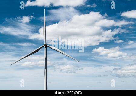 Wind turbine on Whitelee windfarm, Scotland, against deep blue sky. Stock Photo