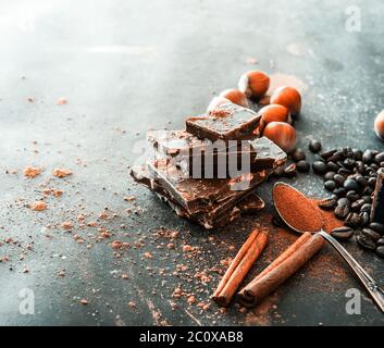 Chocolate, nuts, spices on a smooth black table Stock Photo