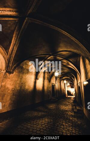 light from the lamp and the shadows in the mysterious corridor in the old dungeon in the castle Stock Photo