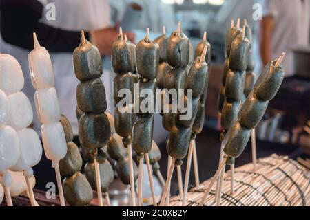 Delicious Japanese mochi on a stick sold on a streets in Hiroshima Japan Stock Photo