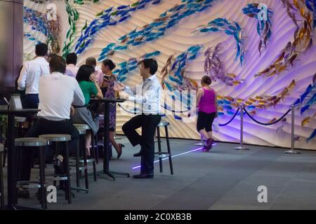 Business people having a drink on the terrace of a cocktail bar after working near UOB Plaza. Downtown. Financial Quarter. Singapore. Stock Photo