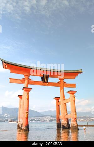 Little girl at the Itsukushima shrine great orange gate O-torii at the Miyajima island in Japan Stock Photo