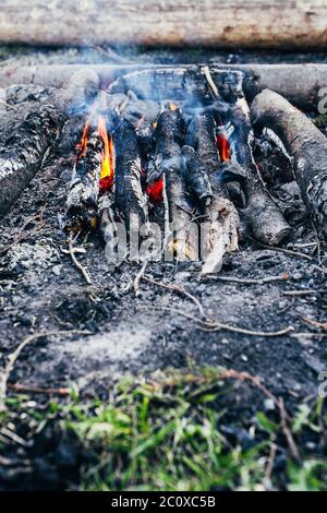 Hot coals from logs in a dying bonfire - cooking in camping conditions Stock Photo