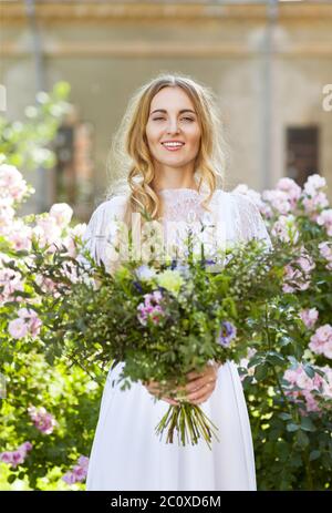 Bride with beautiful wedding bouquet of flowers in the style of boho Stock Photo