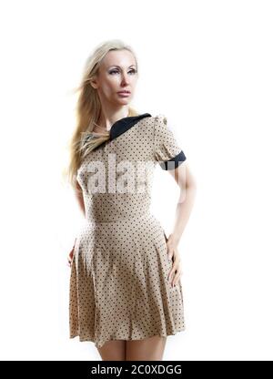 beautiful thoughtful woman in a beige retro style dress with the fair long hair Stock Photo