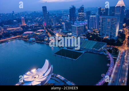 Aerial night view of the skyline of Singapore's downtown viewed from Marina Bay Sands Hotel's terrace. Singapore Stock Photo