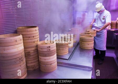 Cookers at works at Din Tai Fung open kitchen. Marina Bay Sands. Singapore Stock Photo