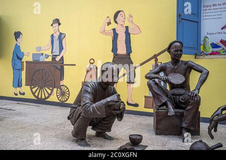 Statues at China Square Centre telling the early history of Singapore. Nankin Street. Singapore. Stock Photo