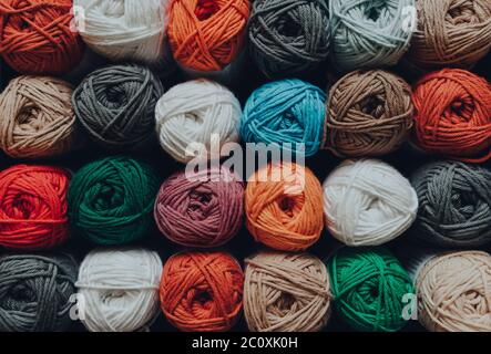 Overhead shot of rows of skeins of amigurumi cotton yarn in different colours, shallow focus. Stock Photo