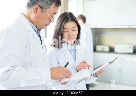 people doing chemical experiment in modern lab Stock Photo