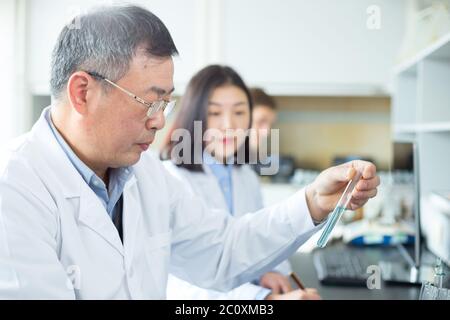 people doing chemical experiment in modern lab Stock Photo