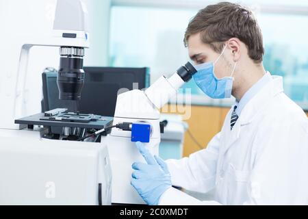 young man does medical experiment in lab Stock Photo