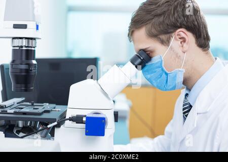 young man does medical experiment in lab Stock Photo
