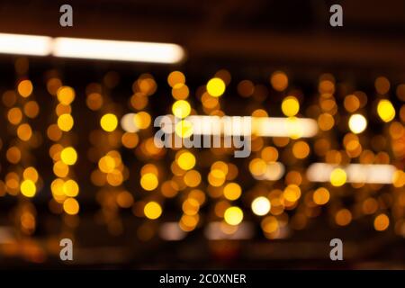 Blurry lights of urban Christmas illumination. Golden bokeh, abstract background. Stock Photo