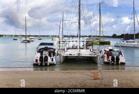 Catamarans and boats in a bay. Grand Bay (Grand Baie) on April 24, 2012 in Mauritius Stock Photo