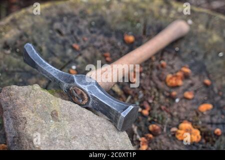 Hand made blacksmith hammer resting on an stump Stock Photo