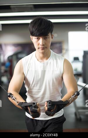 young handsome asian man works out in modern gym Stock Photo