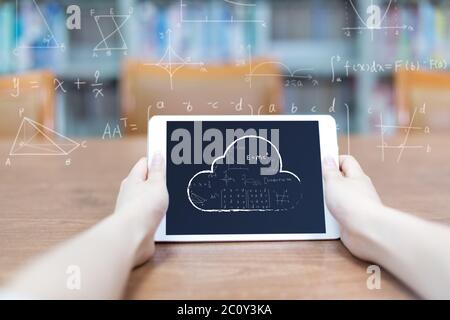 first view of tablet with data cloud in hands on background Stock Photo