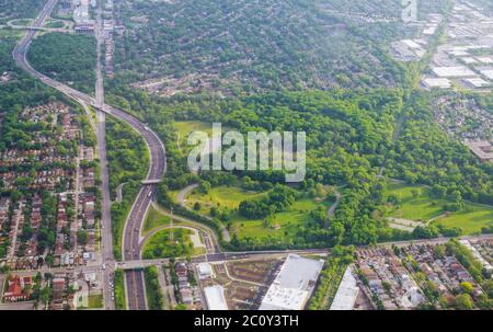 Aerial wide panorama of blue sky with white clouds and green residential area landscape in small town Stock Photo