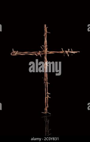 Rusty barbwire cross. Stock Photo