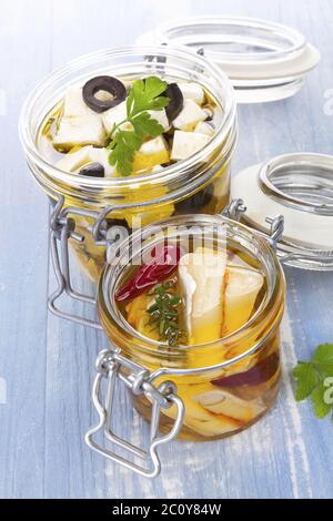 Marinated cheese in glass jar. Stock Photo