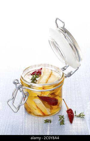 Marinated cheese in glass jar. Stock Photo