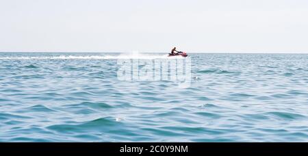 Young guy cruising on a jet ski on the sea Stock Photo