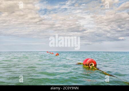 Red buoy on the sea waves background Stock Photo