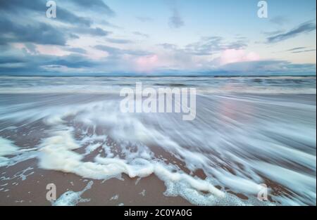 blurred North sea wave at sunrise Stock Photo
