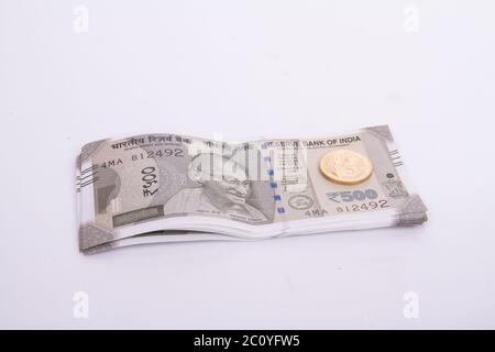Five hundred Rupees with New Indian Five Rupee coin Stock Photo