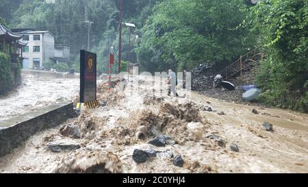 Beijing, China's Chongqing. 12th June, 2020. Staff members of local government block a dike breach in Wuxi County, southwest China's Chongqing, June 12, 2020. Vehement rainstorms have claimed one life while four others are missing in southwest China's Chongqing Municipality, local authorities confirmed Friday. Credit: Deng Aihua/Xinhua/Alamy Live News Stock Photo
