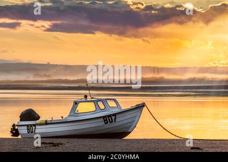 Appledore, North Devon, England. Saturday 13th June 2020. UK Weather. After torrential rain overnight, at dawn calm returns to the River Torridge estuary as the sun breaks through the clouds over Appledore in North Devon. Credit: Terry Mathews/Alamy Live News Stock Photo