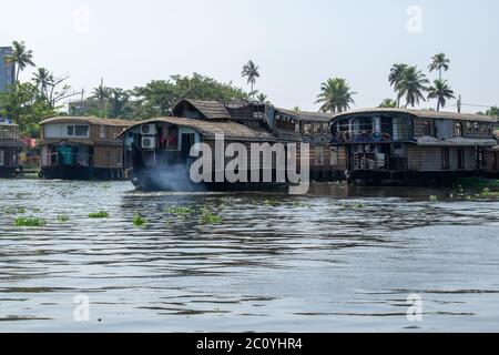 ALAPPUZHA, KERELA, INDIA - JANUARY 22, 2020 - Beautiful Boat house parked on the lake in the bright sun near hotel Stock Photo