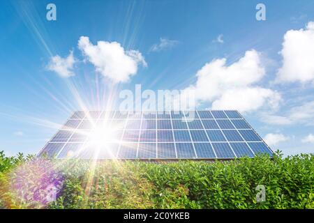 House with solar panels on the roof and scenic sun rays Stock Photo