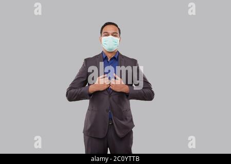 Businessman Standing in Business Pose Wearing Medical Mask Isolated. Indian Business man Standing Isolated Stock Photo