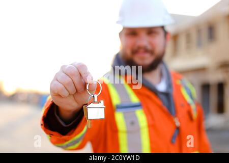 Focus on keys in foreman hands on construction site. Stock Photo