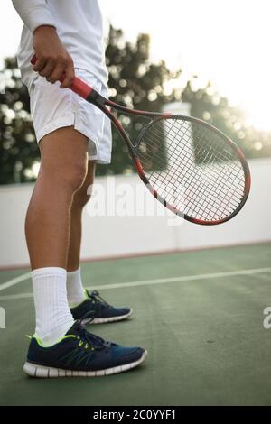 Caucasian man training on a tennis court Stock Photo