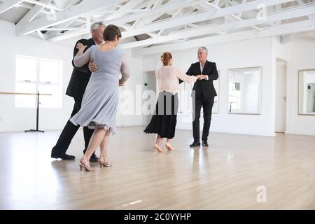Caucasian senior couples ballroom dancing Stock Photo