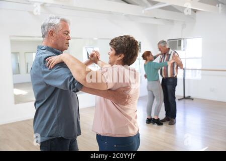 Caucasian senior couples ballroom dancing Stock Photo