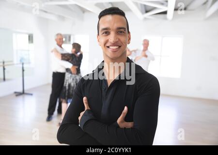 Portrait of mixed race dance teacher during ballroom dancing class Stock Photo