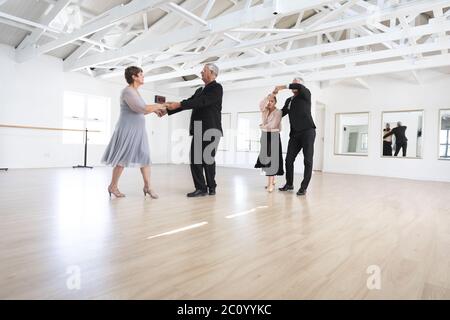 Caucasian senior couples ballroom dancing Stock Photo
