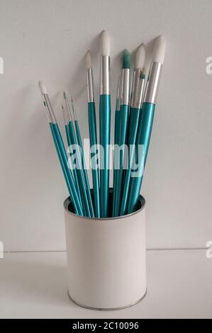 Set of round pointed paint brushes on white stucco background Stock Photo