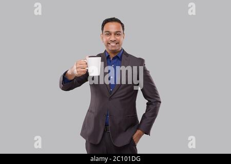 Businessman Holding Coffee Cup. Indian Businessman in Suit with Coffee Cup Stock Photo