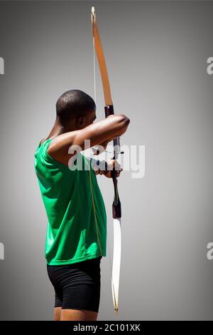 Composite image of rear view of sportsman doing archery on a white background Stock Photo