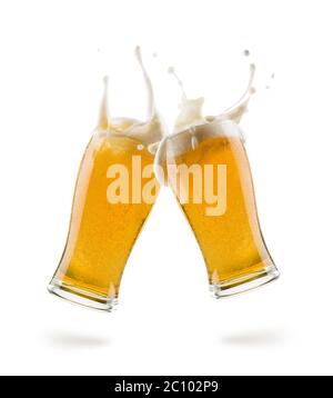 two glasses of lager beer bumping on white background with shadow Stock Photo
