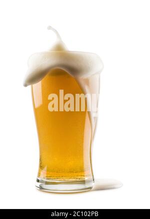 glass of lager beer with overflowing foam on white background Stock Photo