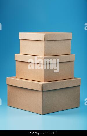 Postal cardboard boxes on a blue background close-up. Stock Photo