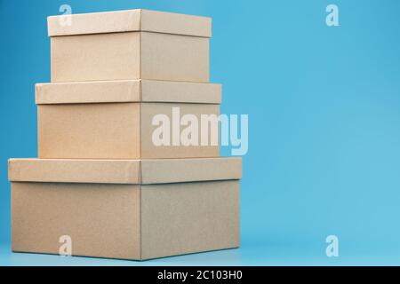 Postal cardboard boxes on a blue background close-up. Stock Photo