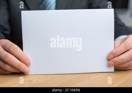 businessman holding white blank paper Stock Photo