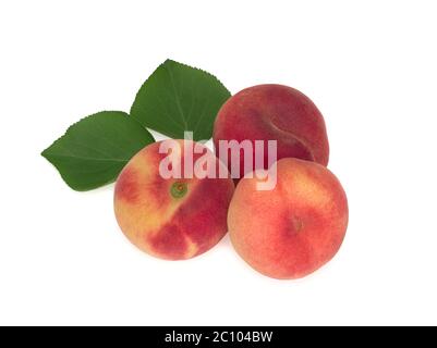 Peaches with leaves isolated on white Stock Photo